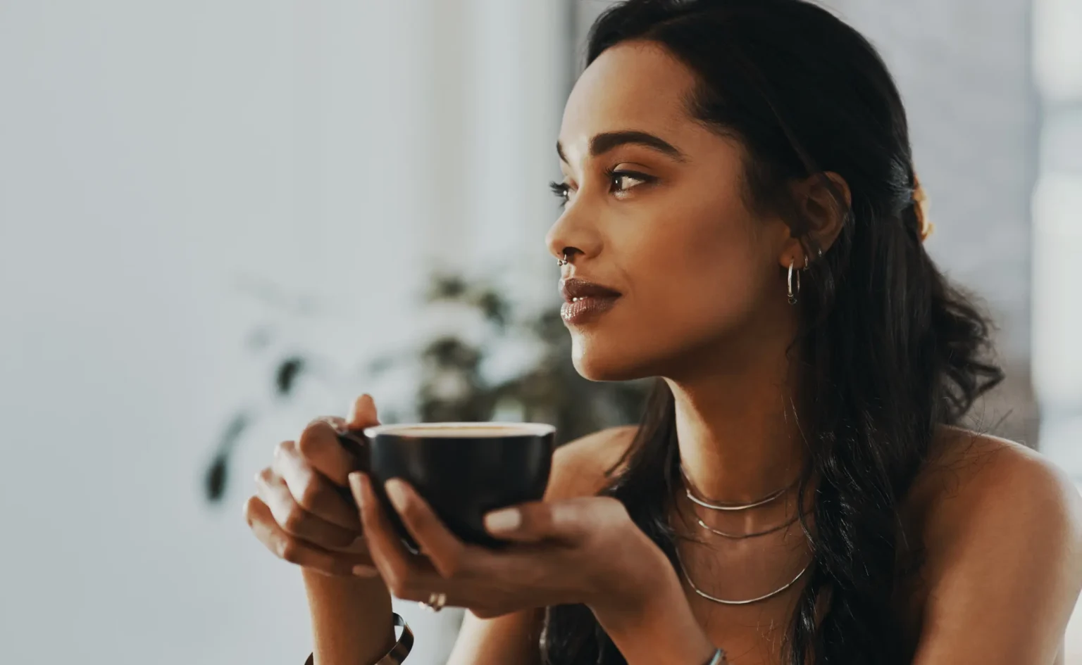 coloured women drinking coffee from a mug